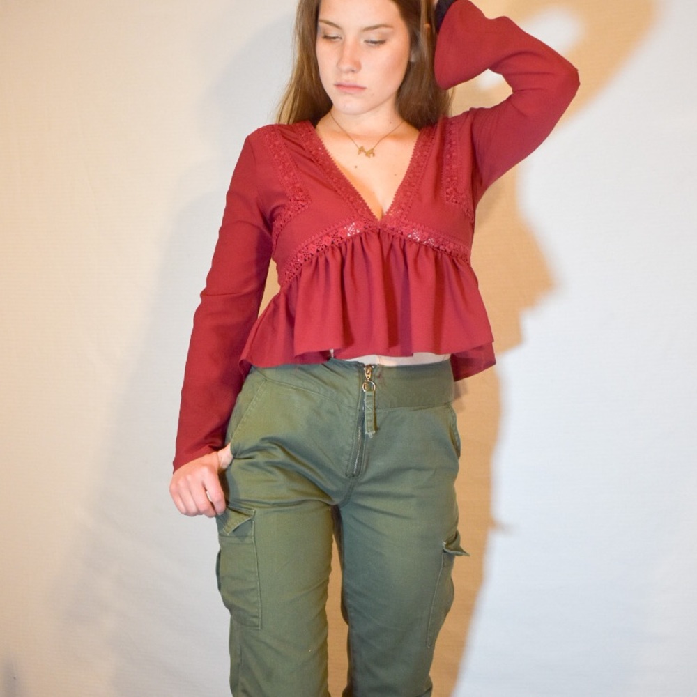 Red V-neck blouse.